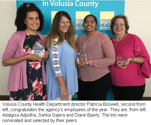 : Volusia County Health Department director Patricia Boswell, second from left, congratulates the agency’s employees of the year. They are, from left: Adalgisa Adjodha, Sarika Gajera and Diane Byerly. The trio were nominated and selected by their peers.