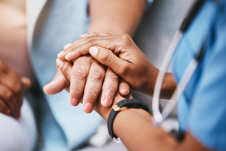 Image of a health care worker helping a patient